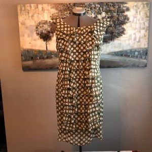 Moss green with white polka dots and front ruffles. Fabulous and fun dress!